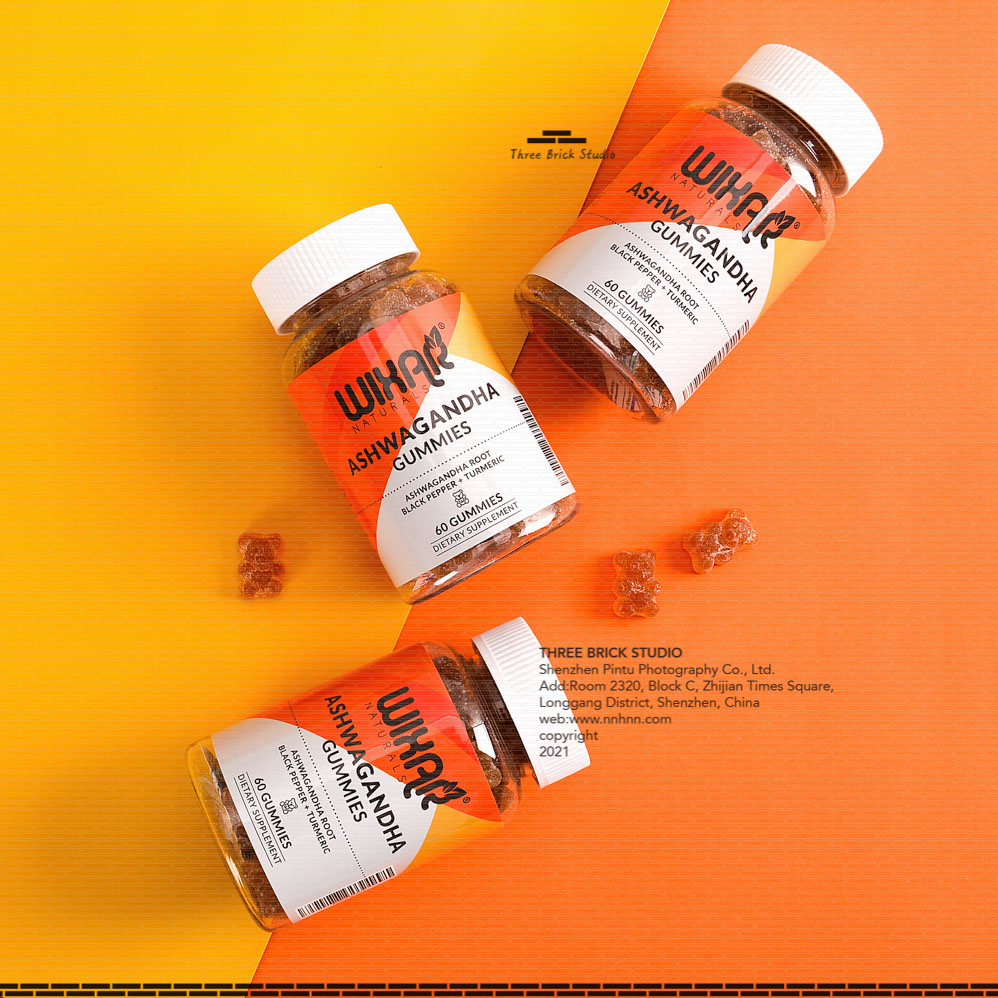 Chinese product photography vitamin bear lifestyle orange / yellow background three bottles